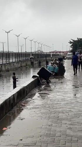 Rainy morning deliveries and construction traffic in Igboefon, Lagos