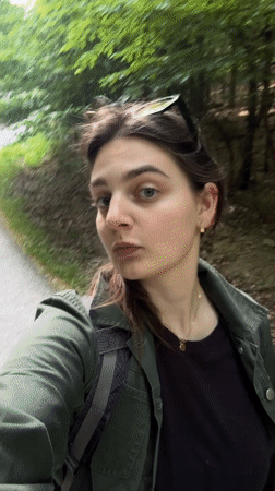 Woman films selfie on forest path in Slovakia