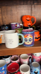 Halloween mug collection documented in Puebla display cabinet