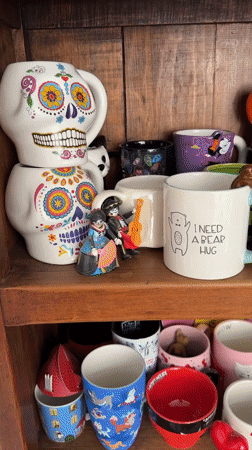 Halloween mug collection documented in Puebla display cabinet