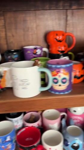 Halloween mug collection documented in Puebla display cabinet