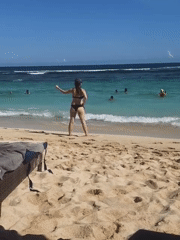 Beachgoers enjoy sunny day swimming at Ungasan beach