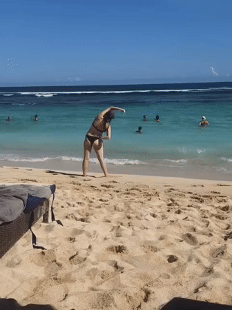 Beachgoers enjoy sunny day swimming at Ungasan beach