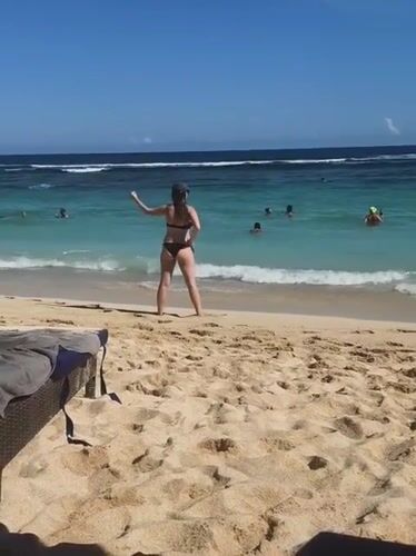 Beachgoers enjoy sunny day swimming at Ungasan beach