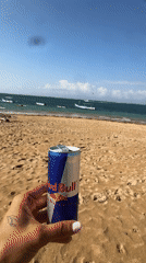 Kitesurfing gear on a Bali beach, Red Bull in hand