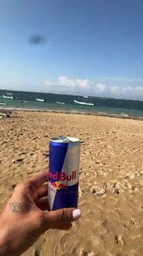 Kitesurfing gear on a Bali beach, Red Bull in hand