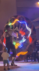 Traditional dancer performs with LED disc in public evening show
