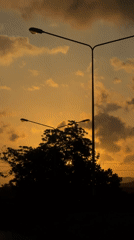 Sunset time-lapse with silhouetted streetlights in Kalai, Thailand