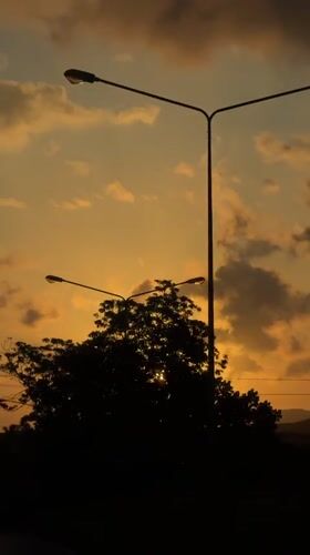 Sunset time-lapse with silhouetted streetlights in Kalai, Thailand