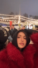 Woman films selfie at outdoor Moscow event