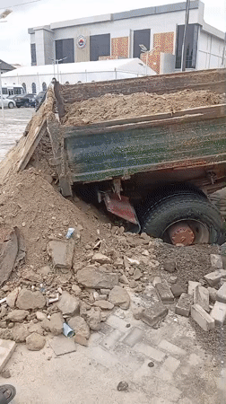 Dump truck sinks into ground, spilling load at Ilado lot