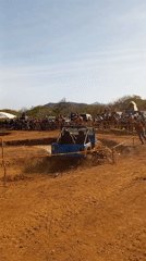 Blue off-road vehicle tackles muddy obstacle course in Venezuela