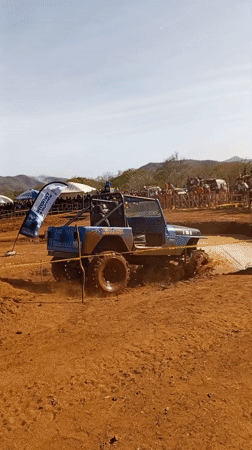Blue off-road vehicle tackles muddy obstacle course in Venezuela