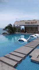 Resort guests enjoy early morning poolside activities in Mui Ne
