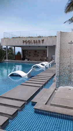 Resort guests enjoy early morning poolside activities in Mui Ne