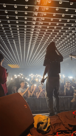 Late-night concert performance featuring DJ and performers in Paris