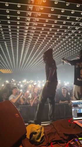 Late-night concert performance featuring DJ and performers in Paris