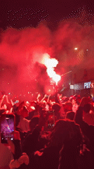 Nighttime gathering with flares and fireworks observed in Paris