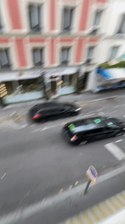 Rainy-day Paris street scenes from a balcony vantage point
