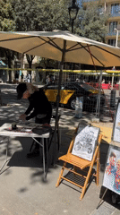 Artist operates outdoor stall in Barcelona public square