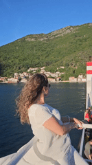 Woman enjoys boat trip in Montenegro's scenic bay