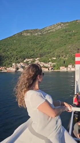 Woman enjoys boat trip in Montenegro's scenic bay