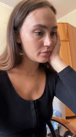 Woman speaks to screen in Surgut apartment setting