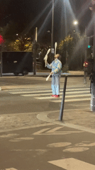 Street juggler performs on Paris crosswalk Sunday night