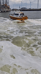 Pilot boat travels through murky waters near Eemshaven