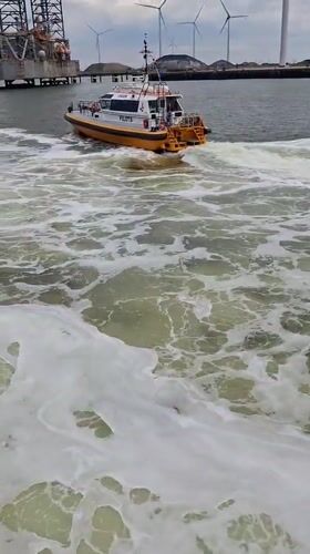 Pilot boat travels through murky waters near Eemshaven