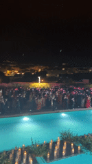 Formal nighttime poolside gathering in Poio, Spain