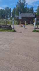 Child plays joyfully amid traditional architecture in sunny Peterhof