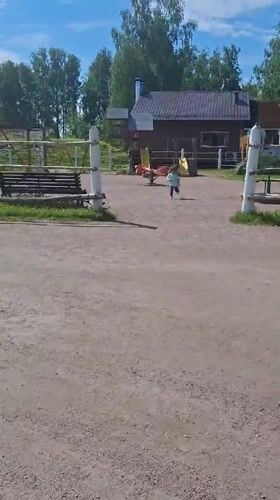 Child plays joyfully amid traditional architecture in sunny Peterhof