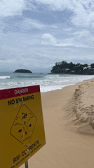Beach safety sign warns of rip currents in Karon
