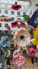 Evening scenes captured at Barcelona shopping center with flowers, diners