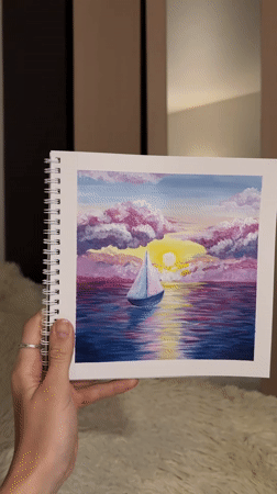 Artist creates sunset sailboat paintings in Perm studio session