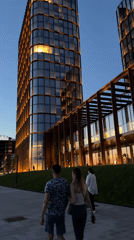 Evening stroll captured near illuminated modern buildings in Kazan