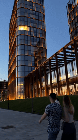 Evening stroll captured near illuminated modern buildings in Kazan