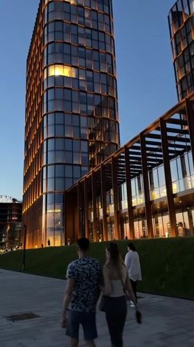 Evening stroll captured near illuminated modern buildings in Kazan