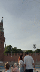 Tourists photograph Kremlin from Moscow River boat tour