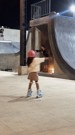 Night skating session at an outdoor skatepark with friends