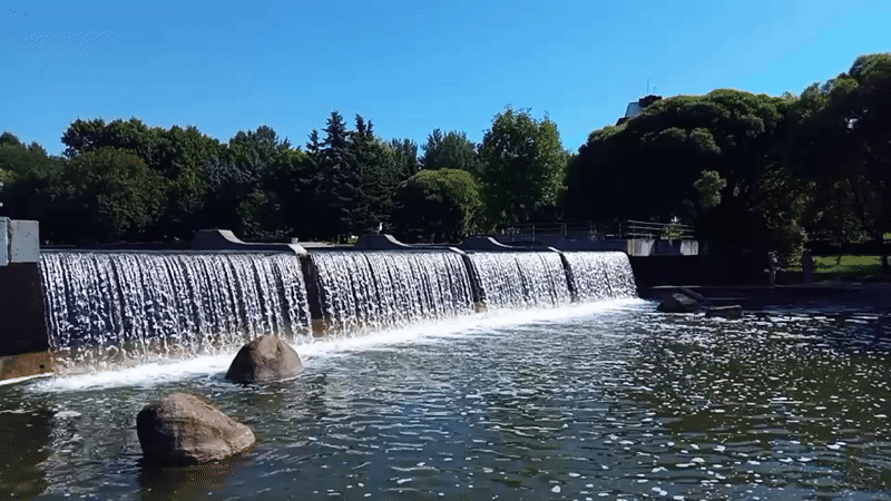 Clear water spills over a concrete dam near Minsk