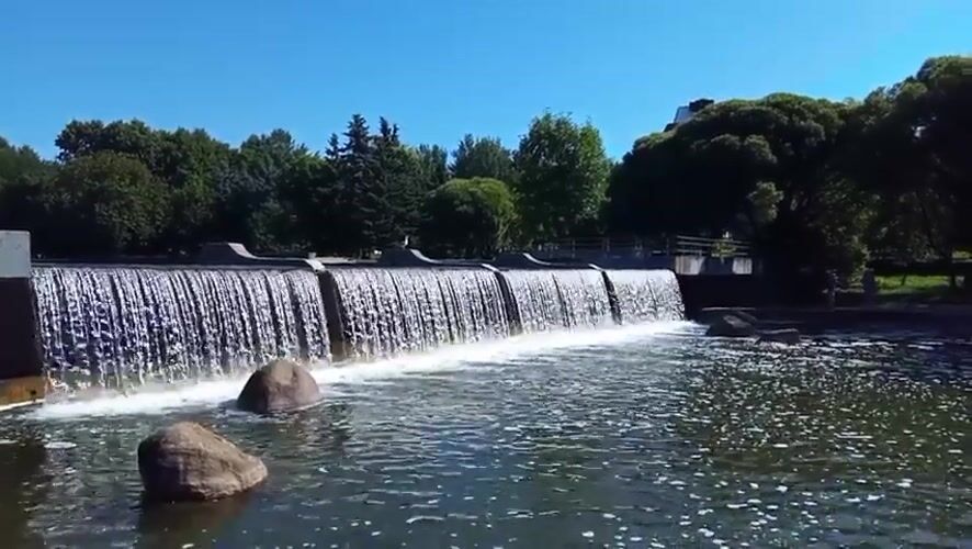 Clear water spills over a concrete dam near Minsk