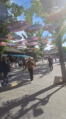 Huairou street market under a canopy of colorful hanging umbrellas