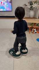 Toddler in oversized slippers captured at Luxembourg home