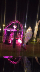 Nighttime dance party with illuminated DJ booth in Kediri