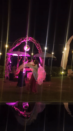 Nighttime dance party with illuminated DJ booth in Kediri