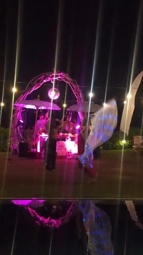 Nighttime dance party with illuminated DJ booth in Kediri