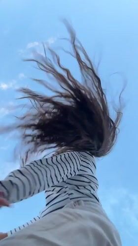 Low-angle portraits against a windy summer sky in rural Russia