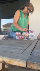 Woman serves ice cream sundaes on French patio